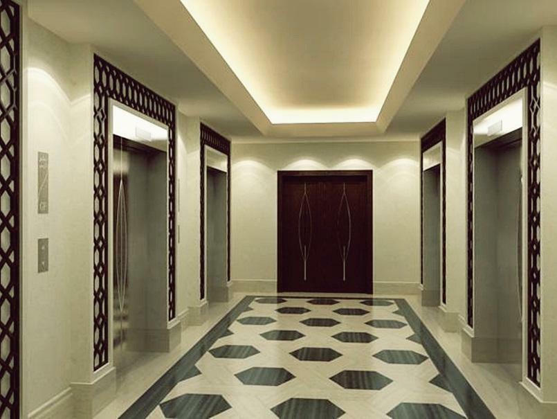 מלון מכה Jabal Omar Hyatt Regency Makkah מראה חיצוני תמונה The photo shows a modern, elegantly designed hotel hallway. It features a symmetrical layout with two sets of elevators on either side. The walls are a soft cream color, which enhances the overall brightness of the space. A sophisticated pattern can 